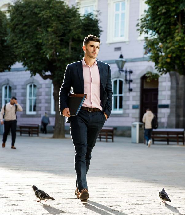 Young professional man walking through Royal Square in St Helier, Jersey