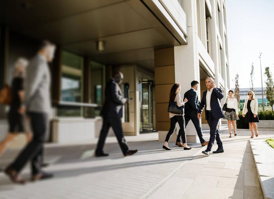Office workers walking outside the Jersey International Finance Centre building