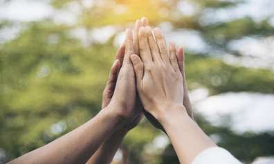 Hands together illustrating team connection