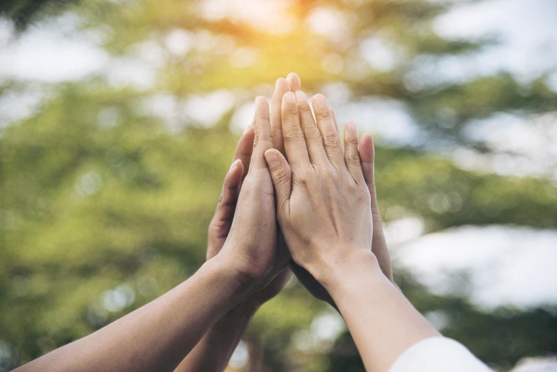 Hands together illustrating team connection