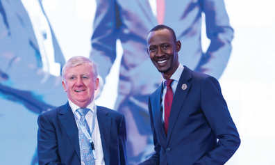 Joe Moynihan and Nick Barigye shaking hands on MoU signing