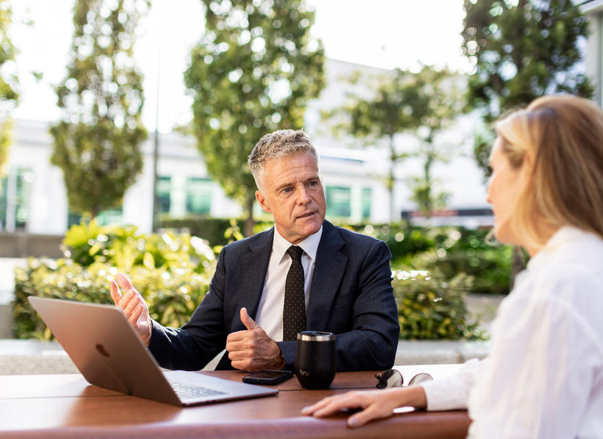 Businessman explaining something during an outdoor discussion with a colleague.