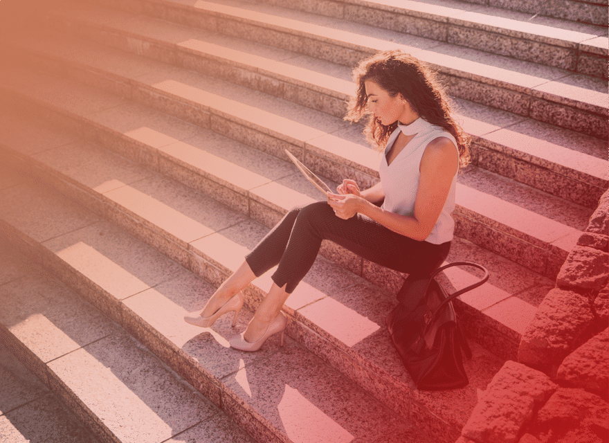 Businesswoman reading report on laptop