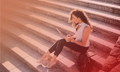 Businesswoman reading report on laptop