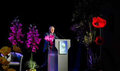Joe Moynihan, Jersey Finance CE, stood behind a lectern on stage as he speaks at the 2025 Sustainable Finance summit