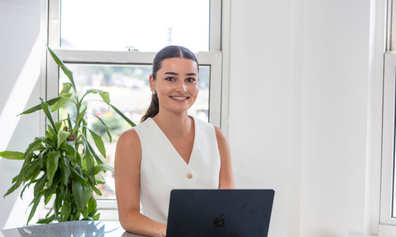 Photo of Ana Martins sitting with laptop
