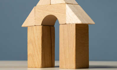 A toy house made of wooden building blocks