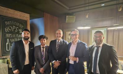 A line-up of business men in a reception room