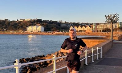 Josh running next to the sea