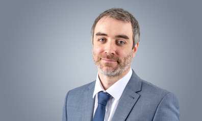 Luke Cornish in a formal suit, looking at the camera