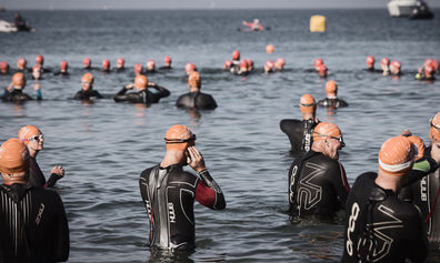 Triathlon participants gathered in the sea before the swim