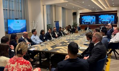 A boardroom table surrounded by business people
