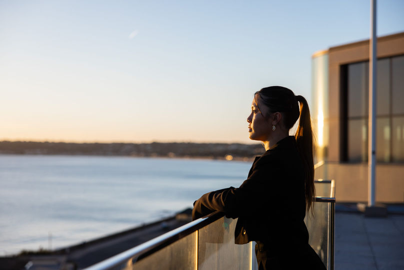 Women overlooking the ocean at sunset