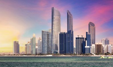 Abu,Dhabi,Skyline,With,Reflection,In,Sea,,United,Arab,Emirates